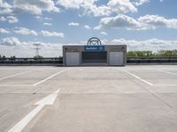 a parking lot at a business with a cloudy background, including white puffy clouds