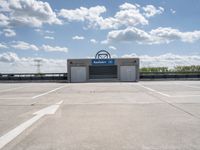 a parking lot at a business with a cloudy background, including white puffy clouds