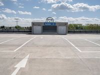 a parking lot at a business with a cloudy background, including white puffy clouds