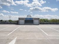 a parking lot at a business with a cloudy background, including white puffy clouds