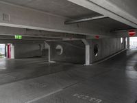 this underground car park has a parking space with cars parked near it and a fire hydrant