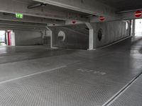 this underground car park has a parking space with cars parked near it and a fire hydrant