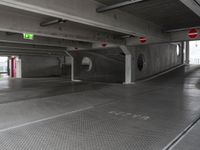 this underground car park has a parking space with cars parked near it and a fire hydrant