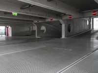 this underground car park has a parking space with cars parked near it and a fire hydrant