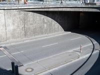 a city street with a road over the street that goes under an overpass with no cars