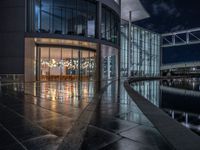 Berlin's Modern Architecture: A Glass Office Building by the Canal at Night