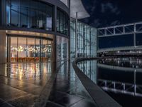 Berlin's Modern Architecture: A Glass Office Building by the Canal at Night