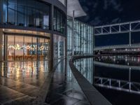 Berlin's Modern Architecture: A Glass Office Building by the Canal at Night