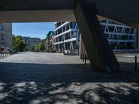 the building has several different angles on it, in varying colors and shapes with brick and concrete floors