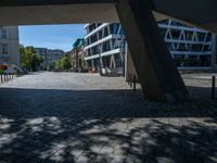 the building has several different angles on it, in varying colors and shapes with brick and concrete floors