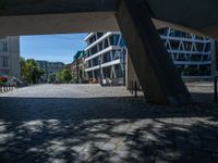 the building has several different angles on it, in varying colors and shapes with brick and concrete floors