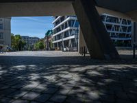 the building has several different angles on it, in varying colors and shapes with brick and concrete floors