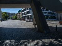 the building has several different angles on it, in varying colors and shapes with brick and concrete floors