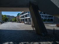 the building has several different angles on it, in varying colors and shapes with brick and concrete floors