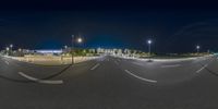 a night shot showing the streetlights and a curve of the road with traffic going under it