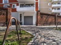 a view from outside of a building that has a red brick wall on the side of it