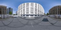 a fish eye lens view of a parking lot and city buildings with construction work in the background