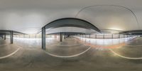 an empty underground parking garage with a circular ceiling view through the windows of the walkway