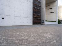 a large, concrete building with a door opened on one side and an entrance on the other side