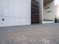 a large, concrete building with a door opened on one side and an entrance on the other side