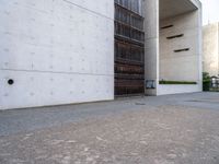 a large, concrete building with a door opened on one side and an entrance on the other side