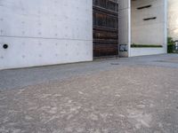 a large, concrete building with a door opened on one side and an entrance on the other side