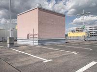 a empty parking lot with no cars, a red fire hydrant and some buildings