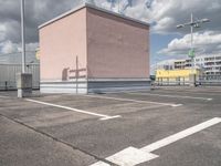 a empty parking lot with no cars, a red fire hydrant and some buildings