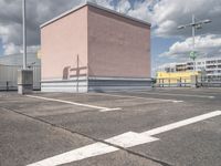 a empty parking lot with no cars, a red fire hydrant and some buildings