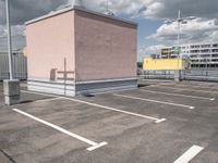 a empty parking lot with no cars, a red fire hydrant and some buildings