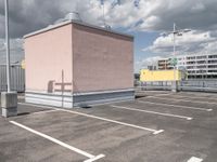 a empty parking lot with no cars, a red fire hydrant and some buildings