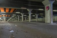 a empty parking garage filled with a lot of parking supplies and trash on the ground