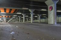 a empty parking garage filled with a lot of parking supplies and trash on the ground