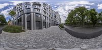 a distorted picture shows a curve of pavement outside a modern building, with a courtyard area