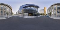 the photo is panoramicly view of a modern building with a curved street