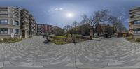 a building and park are viewed from a 360 - view camera view in this circular photo