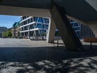 the building has several different angles on it, in varying colors and shapes with brick and concrete floors