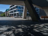 the building has several different angles on it, in varying colors and shapes with brick and concrete floors