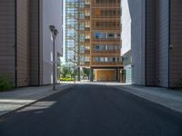 a road through which is a large modern building with an awning over it's entrance