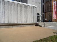 a group of people riding skateboards near wooden panels and stairss with artwork on them