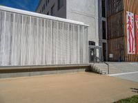 a group of people riding skateboards near wooden panels and stairss with artwork on them