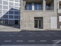 a street corner that has been cleaned and is surrounded by graffiti that says pause on it