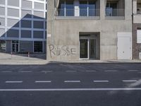 a street corner that has been cleaned and is surrounded by graffiti that says pause on it