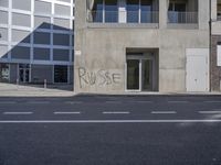 a street corner that has been cleaned and is surrounded by graffiti that says pause on it