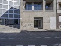 a street corner that has been cleaned and is surrounded by graffiti that says pause on it