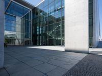 modern commercial building in urban area with large glass windows with a grey cobble floor