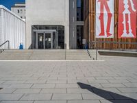 a group of people riding skateboards near wooden panels and stairss with artwork on them