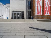 a group of people riding skateboards near wooden panels and stairss with artwork on them