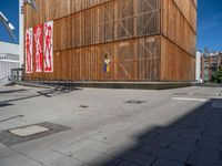 a group of people riding skateboards near wooden panels and stairss with artwork on them