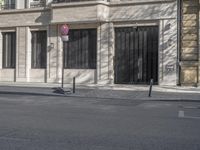 an empty street with two no parking signs on it and the curb has multiple parking spaces